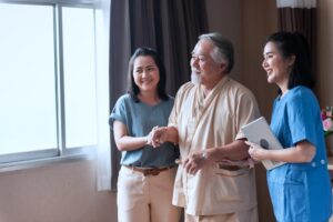 Elderly parent and adult child with nurse at Dallas skilled nursing facility