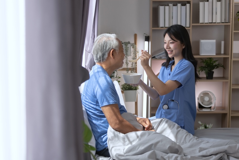 Nurse feeding a client in a skilled nursing facility in Dallas