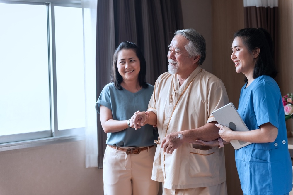 Elderly parent and adult child with nurse at Dallas skilled nursing facility